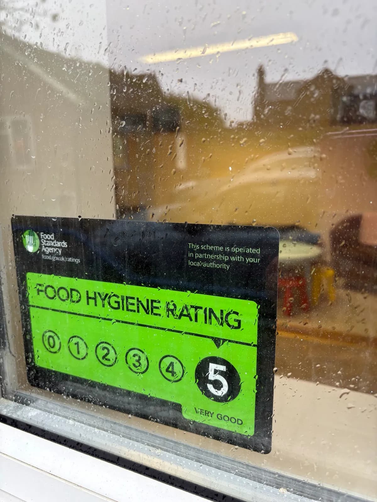A food hygiene rating sticker in the window showing 5, very good.